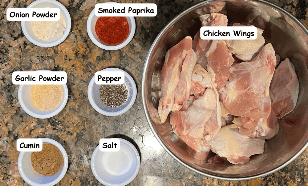 Crispy oven-baked chicken wings ingredients. 
Chicken wings, onion powder, garlic powder, cumin, smoked paprika, black pepper, kosher salt.