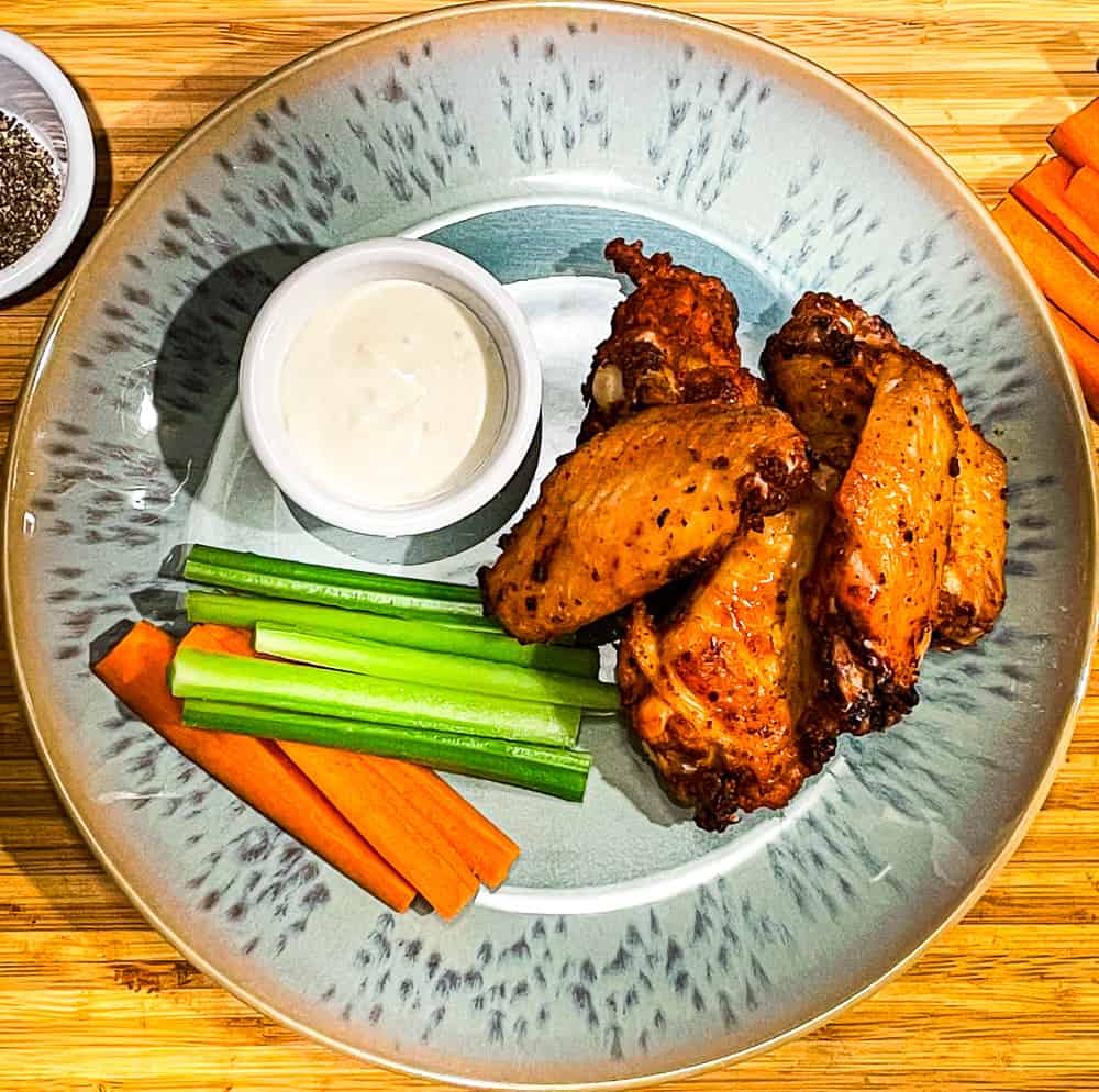 Crispy oven-baked chicken wings with celery, carrots, and bleu cheese dressing. 