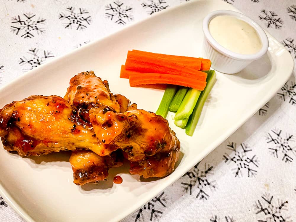 Strawberry Habanero and Jalapeño Pepper Oven-Baked Wings with celery, carrots, and ranch sauce. 
