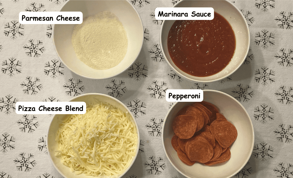 Pepperoni pizza ingredients. Parmesan cheese, marinara sauce, pizza cheese blend, pepperoni