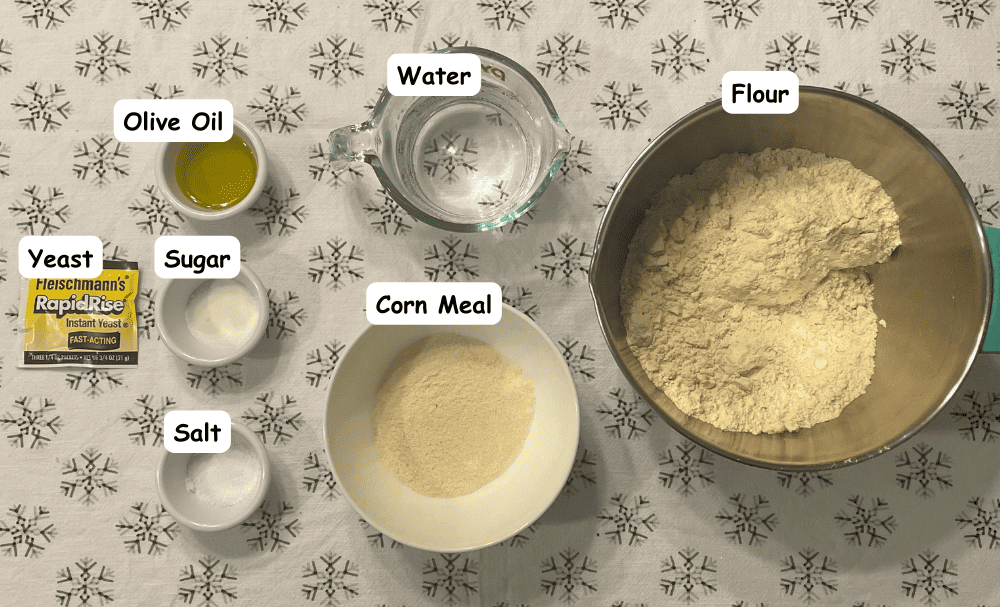 Pizza dough ingredients. Flour, water, corn meal, olive oil, sugar, salt, yeast.